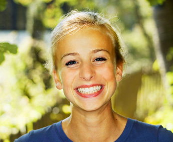Girl with white dental fillings from a Plano dentist near Frisco and Allen TX.