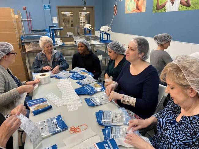 The Plano Dentist packs meals for Feed My Starving Children.
