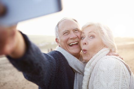 Couple with all on 4 dental implants and permanent dentures are happy about their denture quality thanks to their friendly neighborhood dentist near Plano, Allen, and Frisco TX.