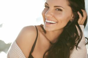 A young lady smiling confidently with white teeth.