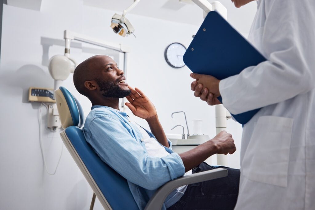 A man consulting with his dentist on the perils of gum disease.