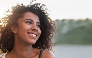 A young woman smiling with new porcelain veneers.