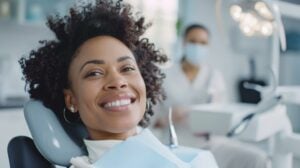 A young woman smiling proudly after teeth whitening treatments in Plano.