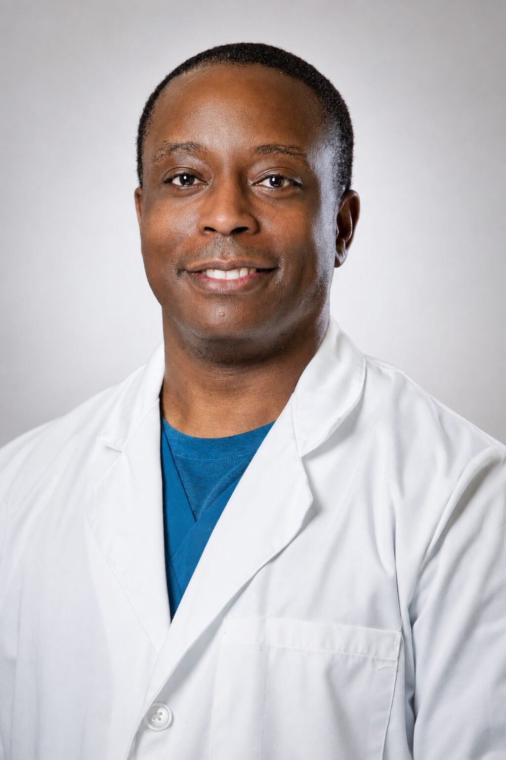 Plano, TX dentist Dr. Igun poses for a professional photo