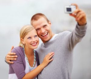 A young couple smiling after having porcelain veneers applied in Plano.